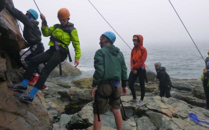 young teens learn rock climbing in maine